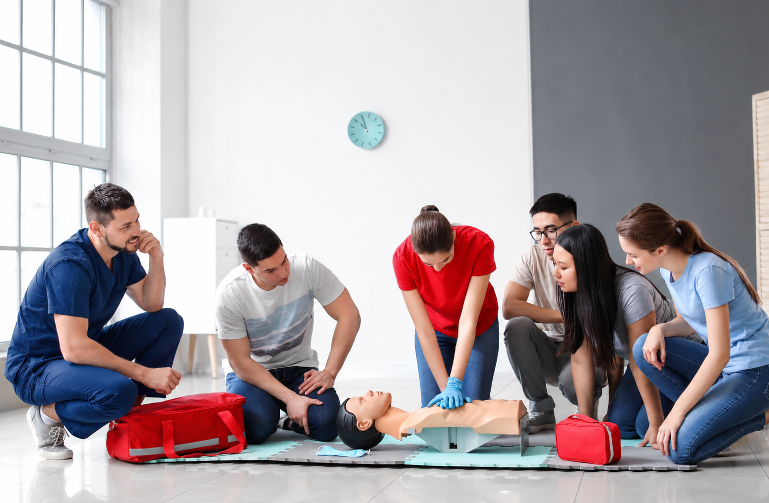 Students practising CPR together with an educator